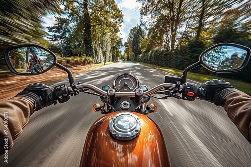 An exhilarating first-person view of a biker riding a motorcycle at high speed on a tree-lined road