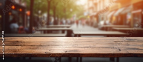 An image of a wooden table top featuring a blurred city street in the background