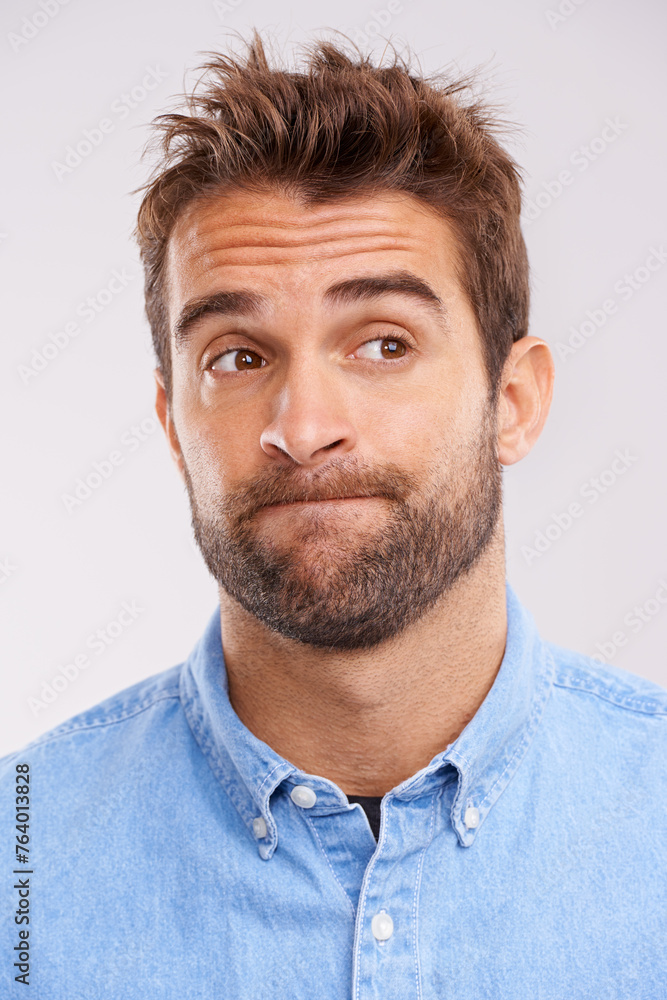 Obraz premium Studio, thinking and bored man with doubt, frustrated and confused on white background. Opinion, disappointment and face of person with decision, conflict or uncertainty for choice, news or ideas