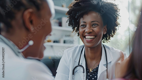 Happy, black woman or doctor consulting a patient in meeting in hospital for healthcare feedback or support. Smile, medical or nurse with a mature person talking or speaking of test results or advice. © Santy Hong