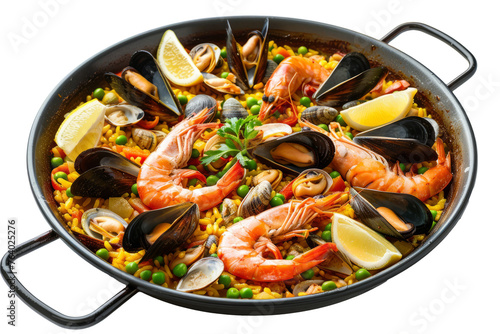 Mediterranean style seafood paella with a colorful assortment of shrimp, mussels and fish fillets, in a large pan on a white surface.