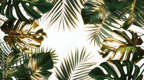 Frame made of various green and gold leaves of tropical plants with space for text
