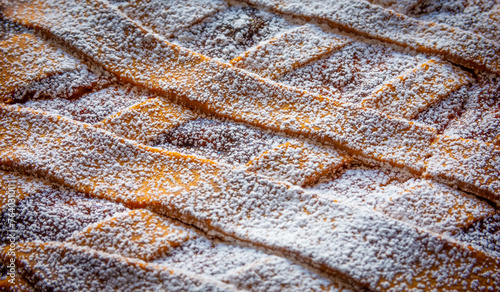Background of Neapolitan Pastiera Crostata, typical italian cake for Easter time. Filled with ricotta and candied fruit, covered with powdered sugar.
