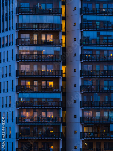 Illuminated Tall Building With Balconies at Night