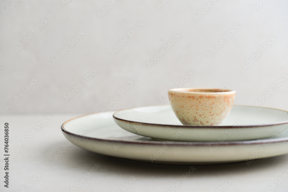 Two plates of different sizes and tiny bowl Two plates of different sizes and tiny bowl