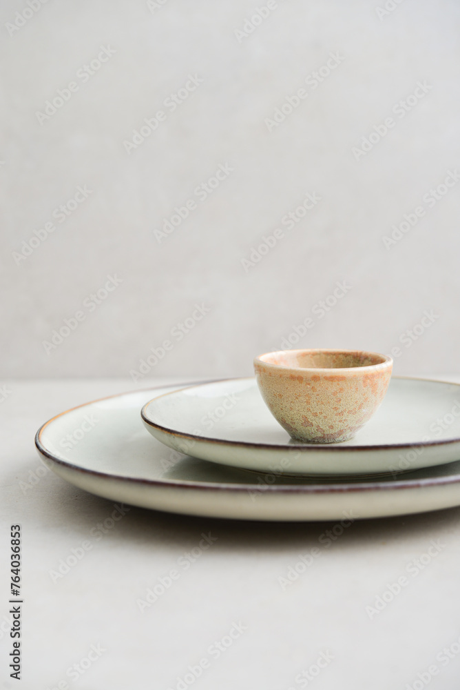 Two plates of different sizes and tiny bowl Two plates of different sizes and tiny bowl