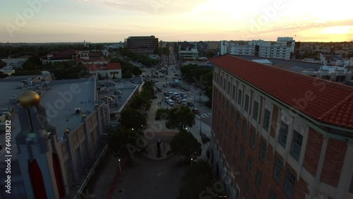 Aerial Forward Scenic View Of Culver Hotel And Theater In City Under Cloudy Sky At Sunset - Culver City, California photo