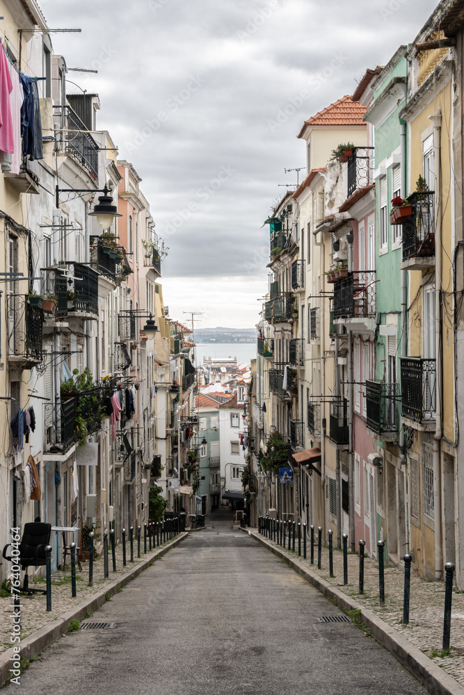Classical narrow Lisbon street leading towards River Tejo