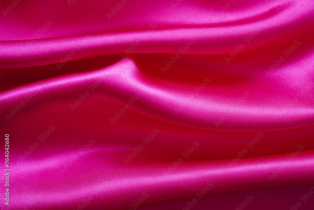 Fototapeta premium Pink silk or satin background, wavy, elegant and elegant. Close-up, background. Space for designblur or blurry