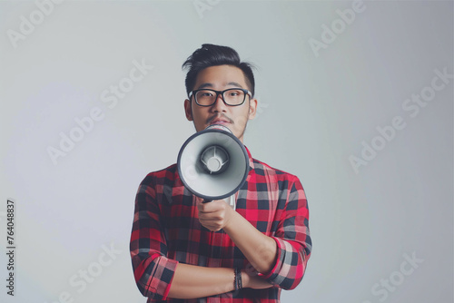 Asian guy wearing a plaid shirt man holding megaphone announces discounts sale, man shouting through a megaphone