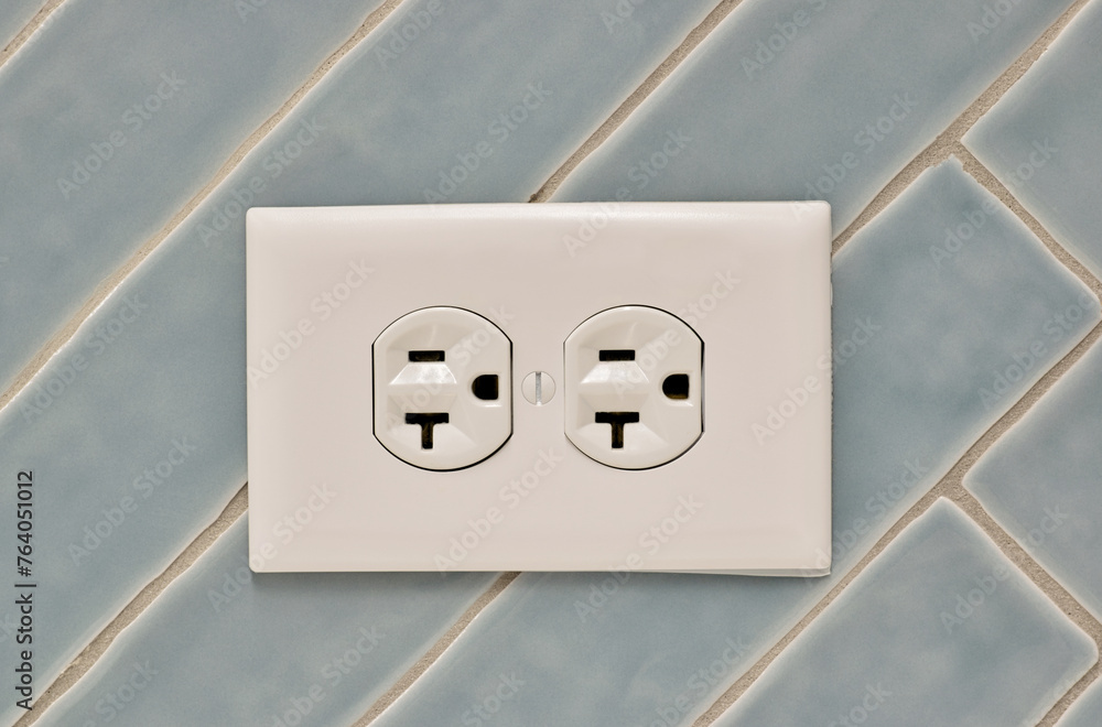 Twin power outlet duplex socket on a tiled wall, USA NEMA 5-15 ...