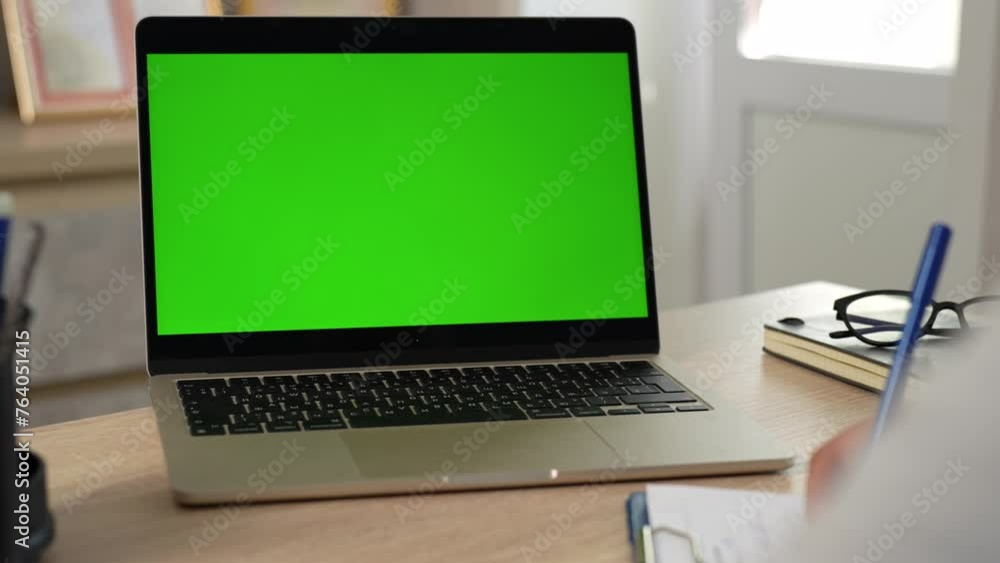 Female doctor writing and watching on laptop computer monitor with green screen, Female doctor writing and watching on laptop computer monitor with green screen,
