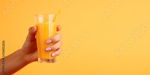 natural juice in a glass in hand Generative AI © Evghenii