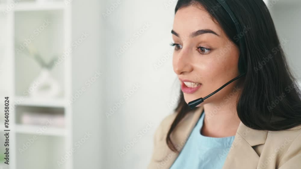 Close-up of multiracial positive woman, call center operator with headset, working on support hotline, communicates with clients, smiles friendly. Customer support service, help desk concept Close-up of multiracial positive woman, call center operator with headset, working on support hotline, communicates with clients, smiles friendly. Customer support service, help desk concept