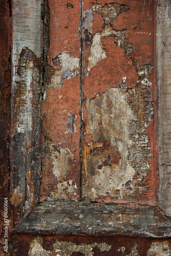 Closeup detail of an old, rotting, wooden door with peeling paint.