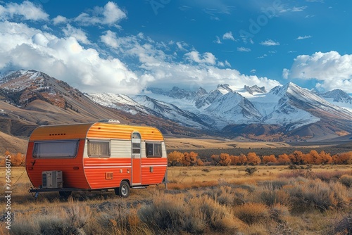 A caravan is centrally placed, with stunning snow-covered mountain backdrop and fall foliage, depicting serene travel © svastix