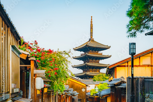 Picturesque Ancient Pagoda Peaks in Historic Japanese Street Lined with Blooms