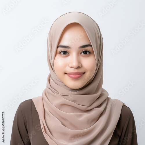 Portrait of a young smiling woman wearing hijab suitable for fashion and cultural diversity themes © Stockules