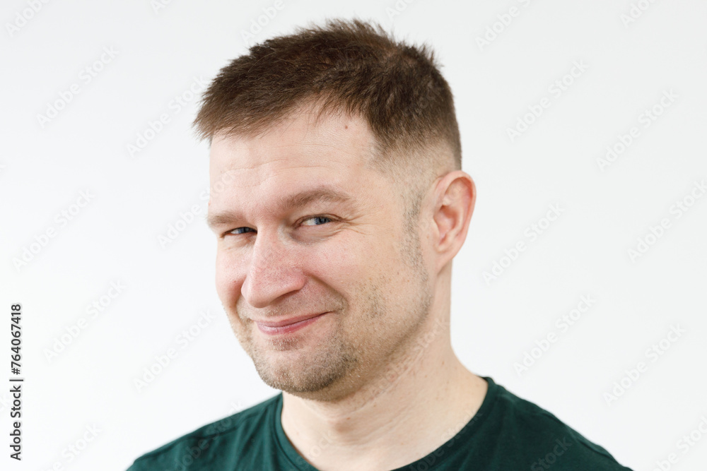 A man in a green T-shirt shows emotions in front of the camera A man in a green T-shirt shows emotions in front of the camera
