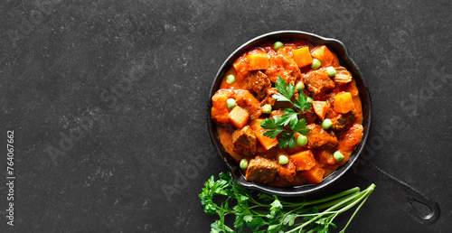 Beef stew with potatoes and carrots in tomato sauce