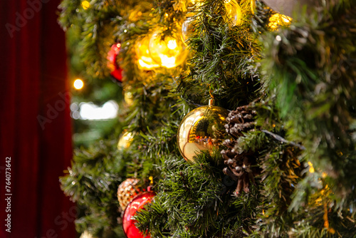 Beautiful Christmas ornament hung on lit tree © VietDung