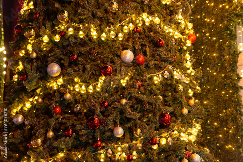 Beautiful Christmas ornament hung on lit tree © VietDung