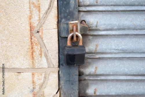 Close Up of Padlock on Steel Roller Shutter Door 