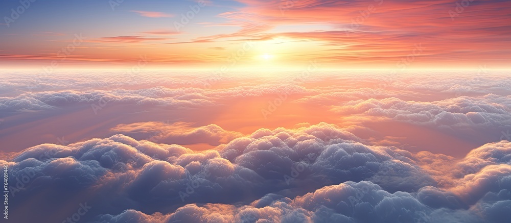 A stunning view of the sun setting over a sky filled with fluffy clouds, creating a vibrant and colorful scene