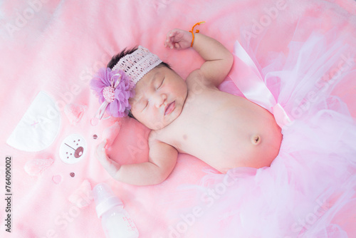 Baby girl and pink blanket,pretty smiling baby girl and teddy bear lying in the bed