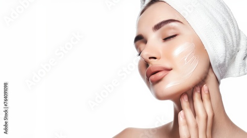The face of a young woman is scraped with a wrinkle smoother on a white background photo