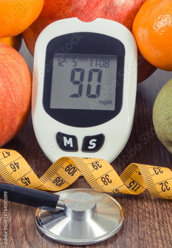 Glucometer with sugar level, fresh fruits, stethoscope and tape measure. Healthy lifestyle and nutrition during diabetes
