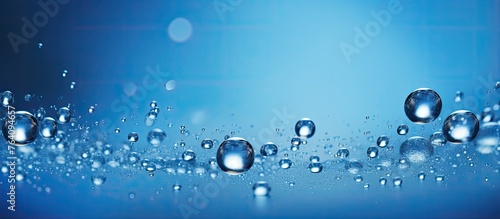 A macro shot showing clear water droplets scattered on a vibrant blue surface