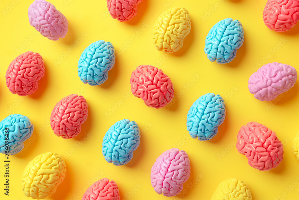 Colorful brains against a pastel yellow background - obrazy, fototapety, plakaty 