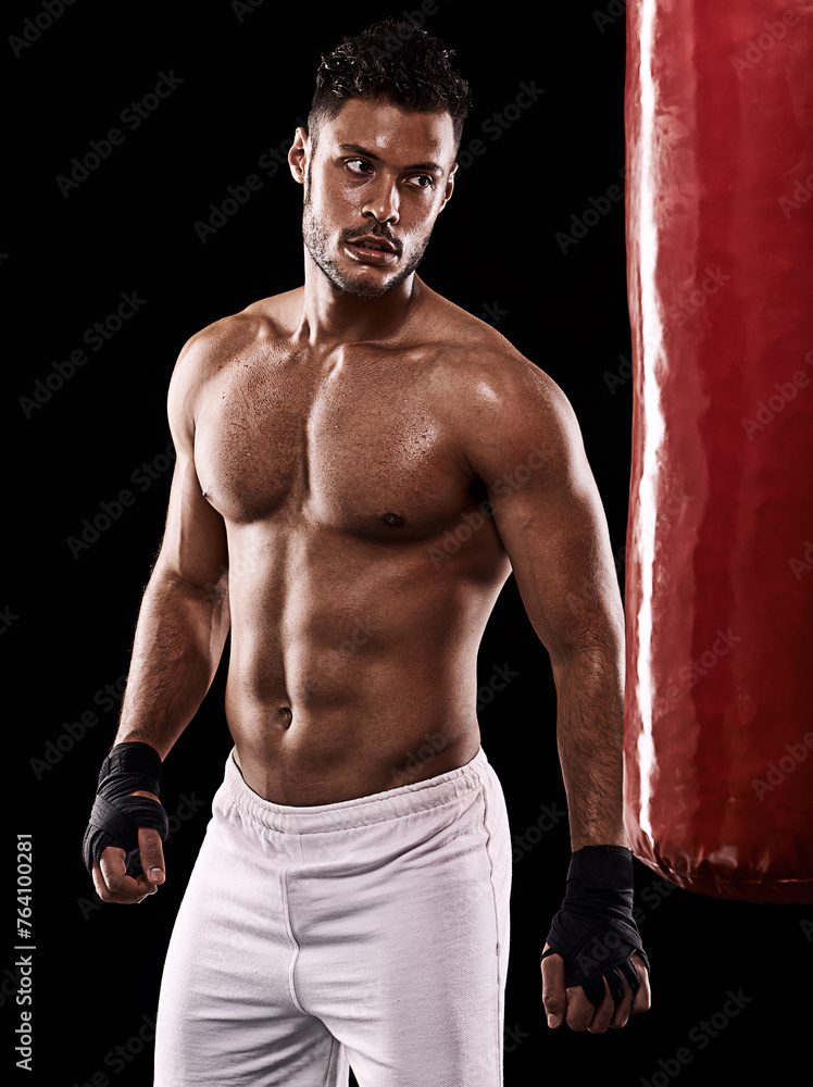 © Duncan M/peopleimages.com - Punching bag, man and boxing with fitness, training for a competition and wellness on a dark studio background. Person, model and guy with exercise and strong with workout and muscular with cardio © Duncan M/peopleimages.com - Punching bag, man and boxing with fitness, training for a competition and wellness on a dark studio background. Person, model and guy with exercise and strong with workout and muscular with cardio