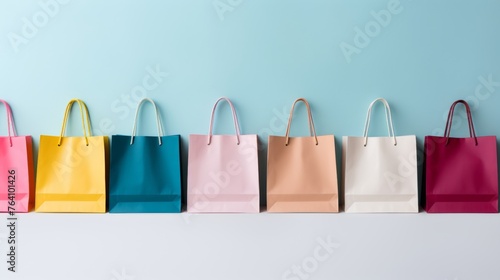 Colorful paper shopping bags held by woman s hand on white background for vibrant shopping
