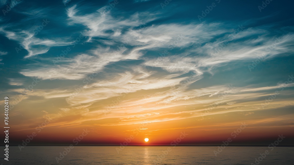 Sun sets over a tranquil blue sky dotted with wispy clouds