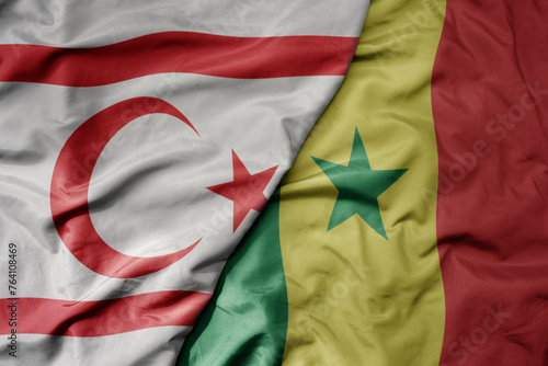 big waving national colorful flag of senegal and national flag of northern cyprus.