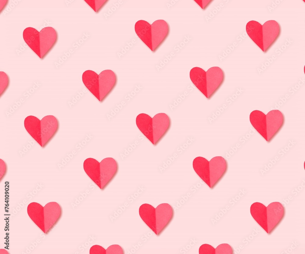 Pink paper hearts on colored background