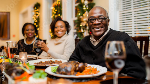 A joyful African American family gathers around the dinner table, celebrating Christmas together with a festive meal.