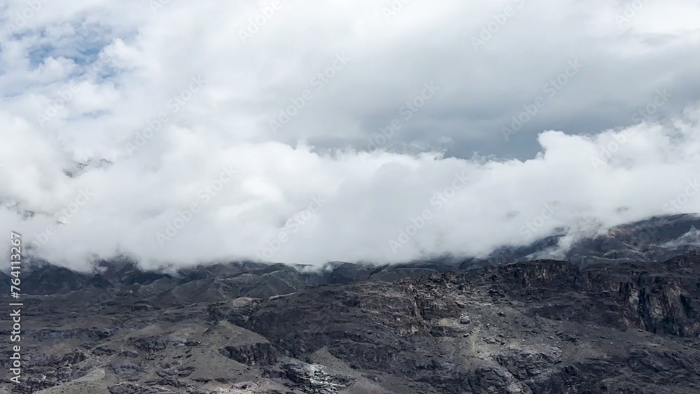 clouds over the mountains Mountain peak dark white clouds cold green weather clouds over the mountains Mountain peak dark white clouds cold green weather