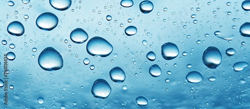 A close up of water droplets condensed on a transparent window glass surface