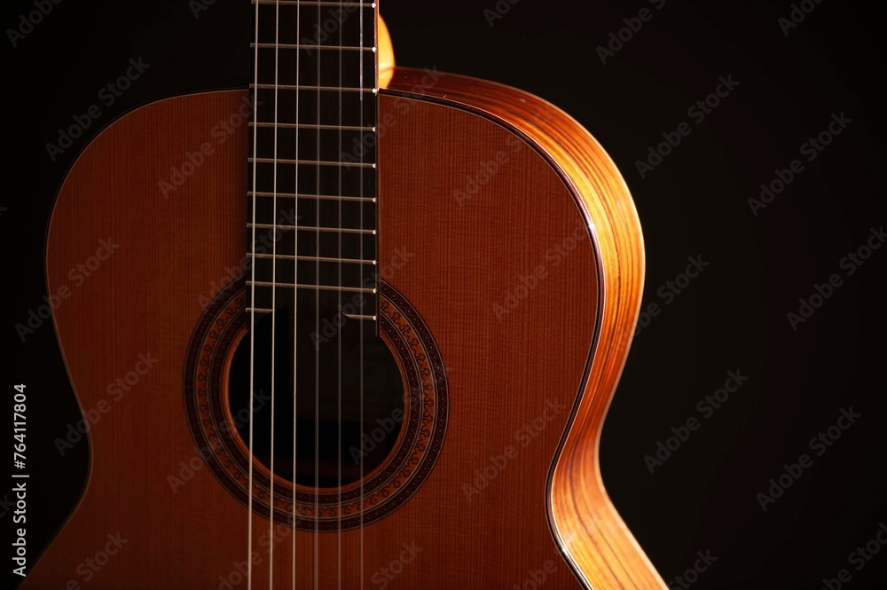 Classical Spanish flamenco guitar close up, dramatically lit isolated on black background with copy space. Classical Spanish flamenco guitar close up, dramatically lit isolated on black background with copy space.