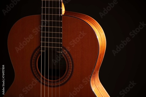 Classical Spanish flamenco guitar close up, dramatically lit isolated on black background with copy space.