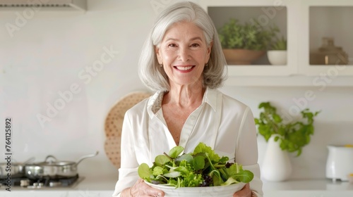 Portrait of a joyful mature woman presenting a bowl of fresh, healthy salad, exemplifying a nutritious diet in a bright, contemporary kitchen setting - AI generated