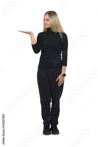 front view of a woman showing an imaginary object in her hand and looking at it on white background.