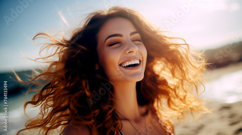 Laughing Young Woman on the Beach on a Sunny Day © PETR BABKIN