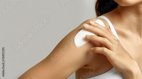 The theme of taking care of women s bodies while applying cream follows the white cream texture  emphasizing the skin s texture and maintaining the softness of women. Close-up photo of woman s skin