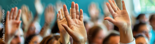 Engaged audience participation with hands raised in a seminar environment