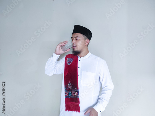 Moslem Asian man drinking a water photo