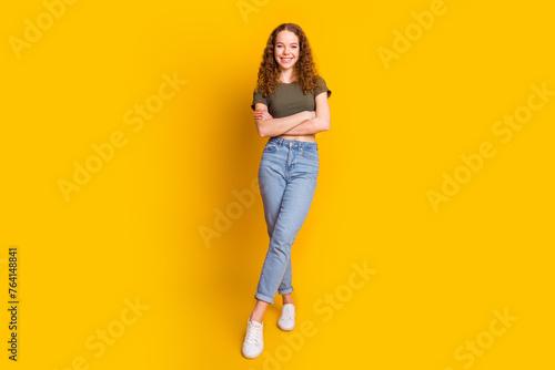 Photo of pretty lovely girl dressed stylish clothes summer collection standing crossed arms isolated on vivid yellow color background